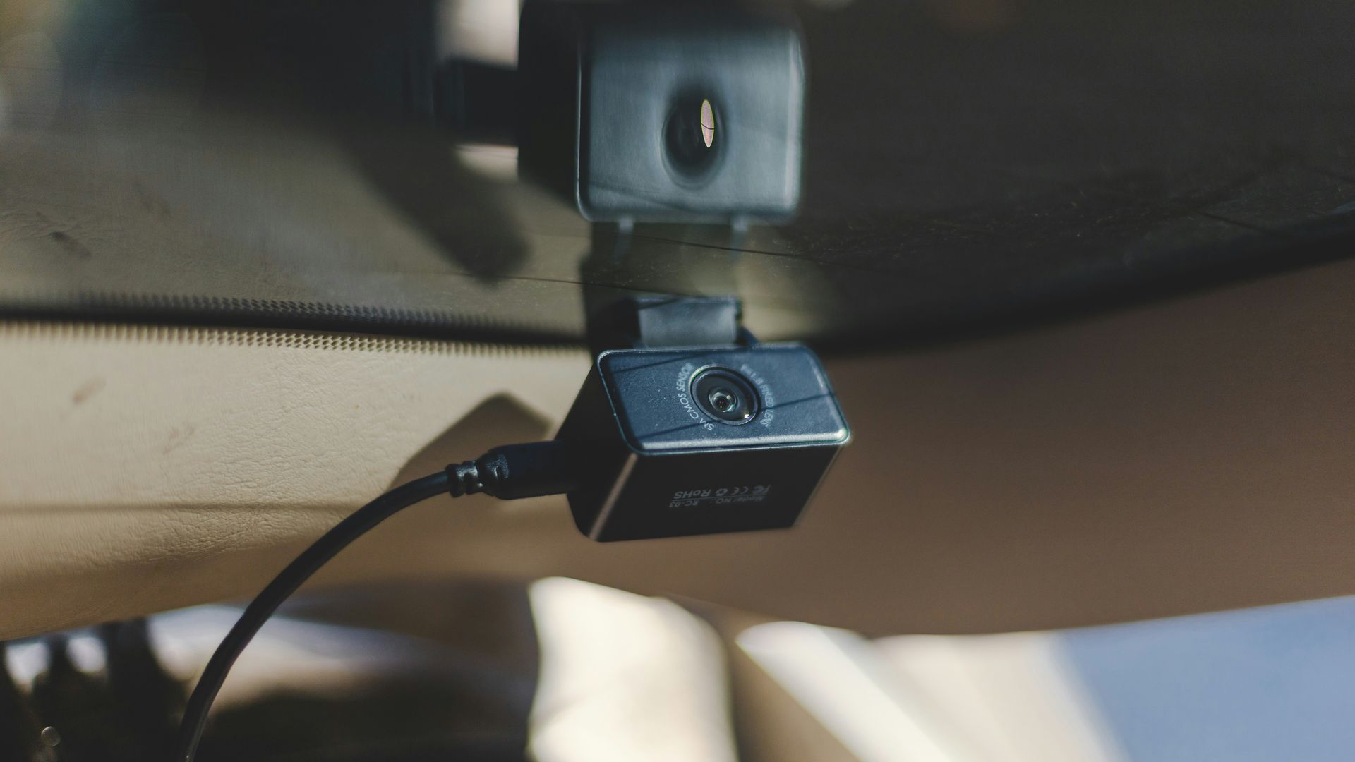 a camera attached to the side of a vehicle